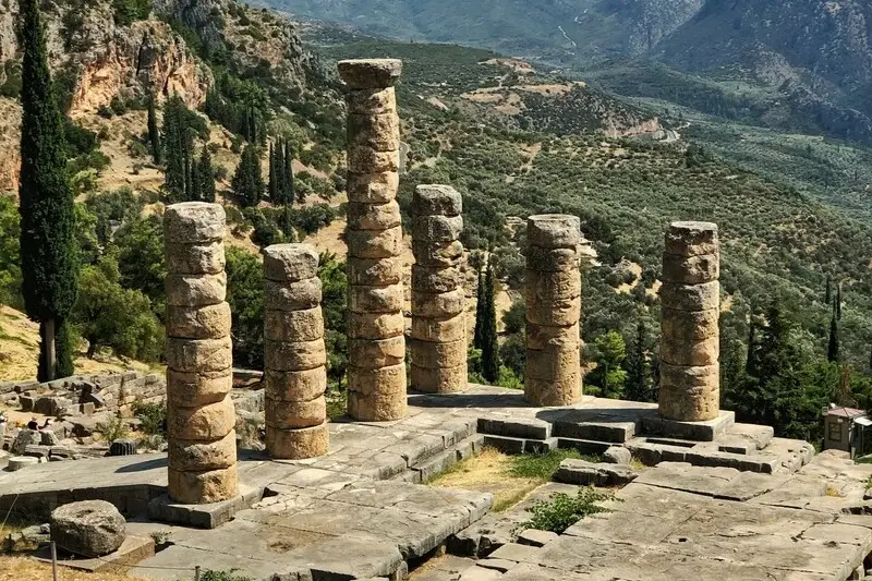 The standing columns of the Temple of Apollo at Delphi against the mountains of Parnassus