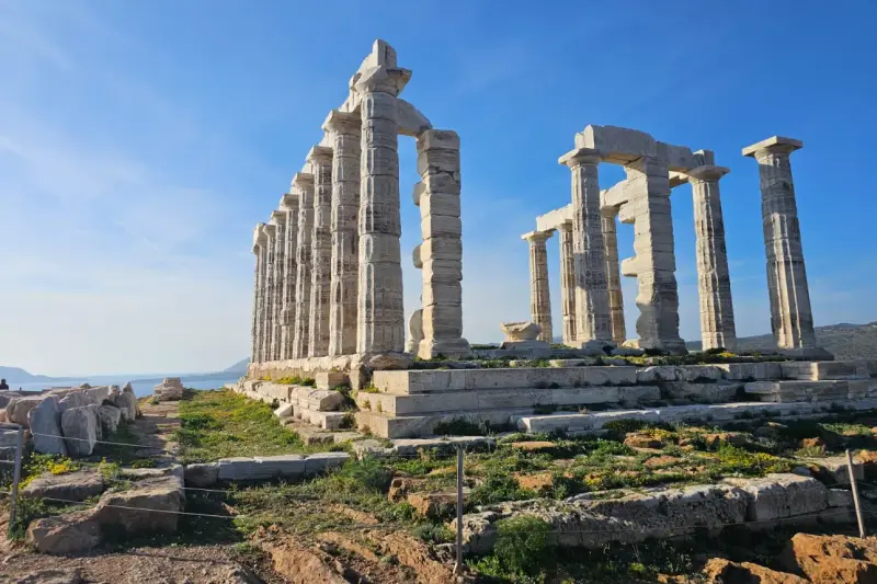 Close view of the Doric columns of the Temple of Poseidon against a clear blue sky